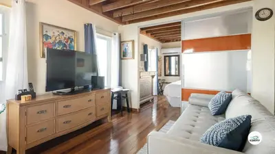a living room with a couch and a flat screen tv at Komffy Studio Waterfront w/King Bed & Free Parking in Hollywood