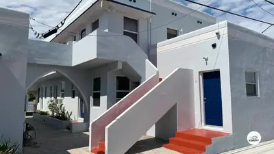 a white house with a staircase in front of it at Komffy Studio Waterfront w/King Bed & Free Parking in Hollywood