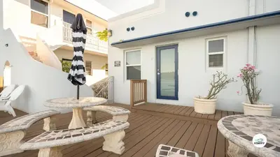 a patio with two benches and an umbrella at Komffy Studio Waterfront w/King Bed & Free Parking in Hollywood
