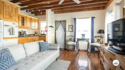 a living room with a white couch and a kitchen at Komffy Studio Waterfront w/King Bed & Free Parking in Hollywood