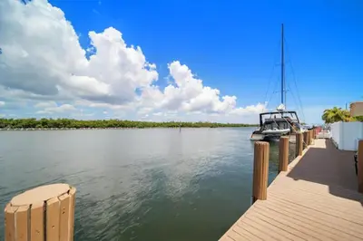 a boat is docked at a dock on the water at Waterside Escape w/Queen Bed & Free Parking in Hollywood
