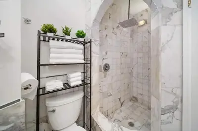 a white bathroom with a shower and a toilet at Waterside Escape w/Queen Bed & Free Parking in Hollywood
