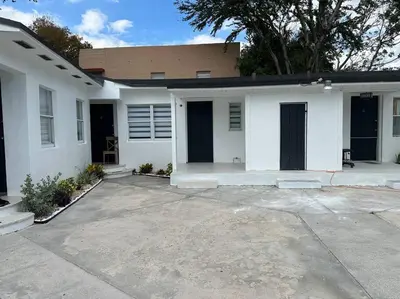 a white house with a driveway in front of it at VillaClara Studio-Little Havana in Miami