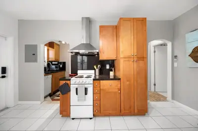 a kitchen with wooden cabinets and a stove top oven at Komffy Intercoastal retreat King Bed, Free Parking in Hollywood