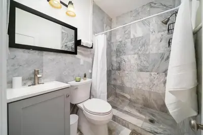 a bathroom with a toilet and a sink and a shower at Waterside Studio w/ King bed - Hollywood in Hollywood