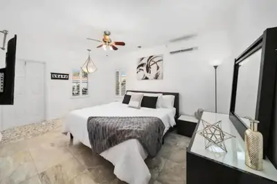 a bedroom with a bed and a ceiling fan at Waterside Studio w/ King bed - Hollywood in Hollywood