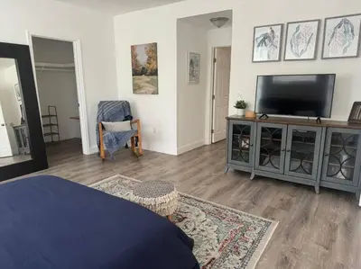 a living room with a flat screen tv on a entertainment center at Brickell + Wynwood Wonderland: Spacious 6BR Home in Miami