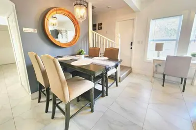 a dining room with a table and chairs and a mirror at Brickell + Wynwood Wonderland: Spacious 6BR Home in Miami