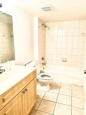 a bathroom with a toilet and a tub and a sink at Private bedroom 1 block from Downtown Miami in Miami