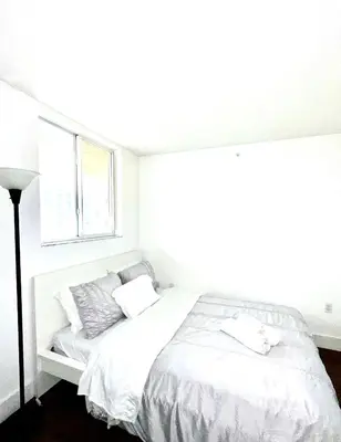 a white bedroom with a bed and a window at Private bedroom 1 block from Downtown Miami in Miami