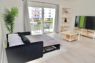 a living room with a couch and a flat screen tv at 1BR with Kitchen Close To Sunny Isles Beach in North Miami Beach