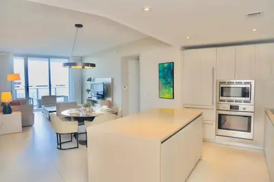 a kitchen and living room with a table and a microwave at Luxury 2 Bedroom Ocean View en Hyde Resort in Hollywood