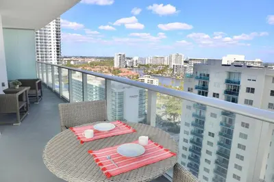 a balcony with a table and chairs with a view of a city at Luxury 2 Bedroom Ocean View en Hyde Resort in Hollywood