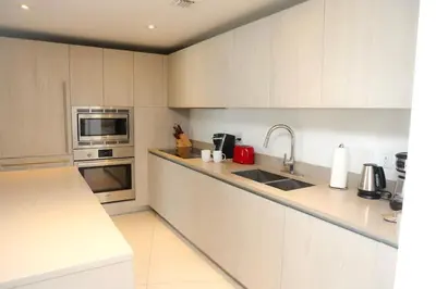 a white kitchen with a sink and a microwave at Luxury 2 Bedroom Ocean View en Hyde Resort in Hollywood