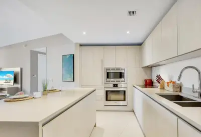 a white kitchen with white counters and appliances at Luxury 2 Bedroom Ocean View en Hyde Resort in Hollywood