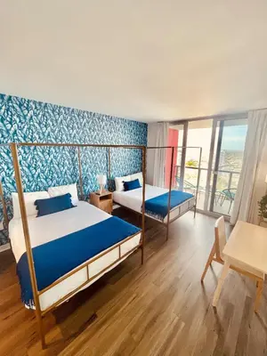 a bedroom with a bed and a desk and a table at 2BR-2BA Oasis W-Stunning Views at Beachwalk in Hallandale Beach