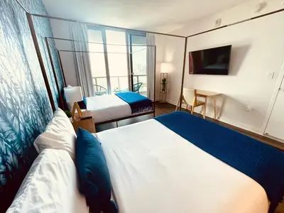 a hotel room with two beds and a window at 2BR-2BA Oasis W-Stunning Views at Beachwalk in Hallandale Beach