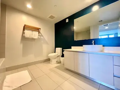 a bathroom with a sink and a toilet and a mirror at Beachwalk -1 Bedroom W-Kitchen and Great Views in Hallandale Beach