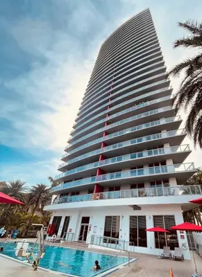 a tall building with a swimming pool in front of it at Beachwalk -1 Bedroom W-Kitchen and Great Views in Hallandale Beach