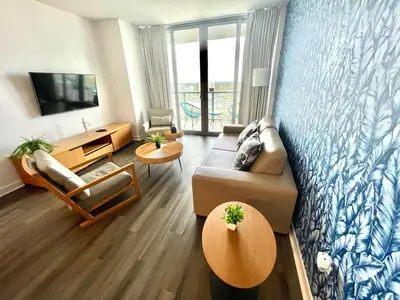 a living room with a couch and a tv at Beachwalk -1 Bedroom W-Kitchen and Great Views in Hallandale Beach