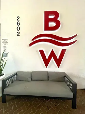 a couch in front of a wall with a wii sign at Beachwalk Studio W-Kitchenette Beach Pool Gym in Hallandale Beach