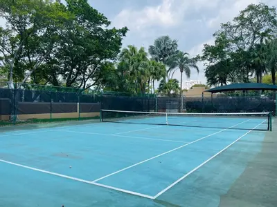a tennis court with a net on it at 2 Luxury Bedrooms at Yacht Club de Aventura in Miami