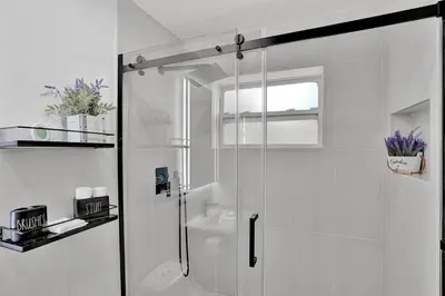 a white bathroom with a shower and a sink at Hallandale Beach Modern apartment Chic Backyard in Hallandale Beach
