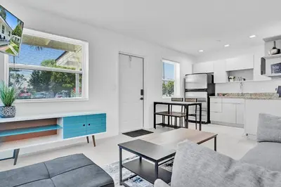 a living room with a couch and a table at Hallandale Beach Modern apartment Chic Backyard in Hallandale Beach