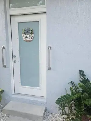 a white door with a sign on the side of a building at D&N Property Rental in Miami