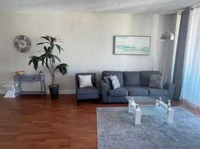 a living room with a couch and a table at Ocean view 1 bedroom in Hollywood in Hollywood