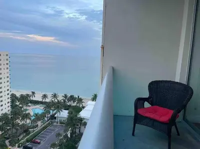 a chair on a balcony with a view of the ocean at Ocean view 1 bedroom in Hollywood in Hollywood