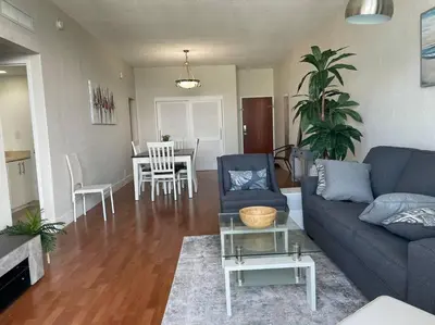 a living room with a blue couch and a table at Ocean view 1 bedroom in Hollywood in Hollywood