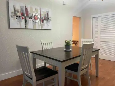 a dining room table with chairs and a picture on the wall at Ocean view 1 bedroom in Hollywood in Hollywood