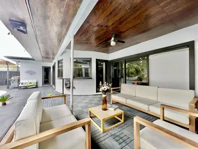 a living room with white furniture and a wooden ceiling at Casa Olan - Luxury Family Oasis 3BR North Miami Beach Villa with Saltwater Pool & Canal Views in Miami