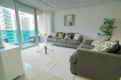 a living room with a couch and a table at Amazing apartment by the Ocean in Hollywood