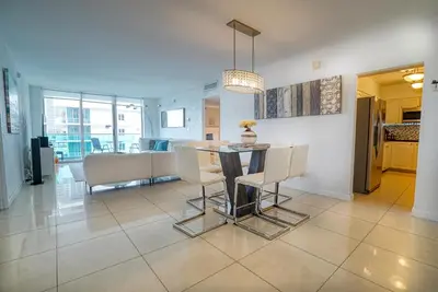 a dining room and kitchen with a table and chairs at Amazing apartment by the Ocean in Hollywood