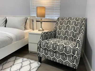 a bedroom with a chair next to a bed at Rachaels Upscale 3 bedrooms Luxury Home in Fort Lauderdale