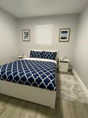 a bedroom with a bed with a blue and white comforter at Rachaels Upscale 3 bedrooms Luxury Home in Fort Lauderdale