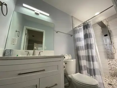 a bathroom with a sink and a toilet and a mirror at Rachaels Upscale 3 bedrooms Luxury Home in Fort Lauderdale