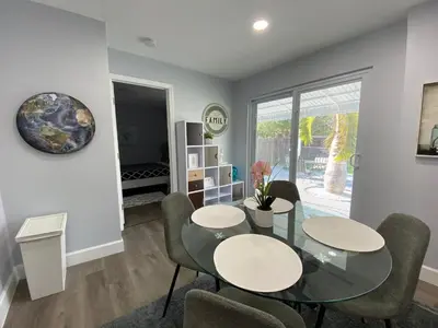 a dining room with a glass table and chairs at Rachaels Upscale 3 bedrooms Luxury Home in Fort Lauderdale