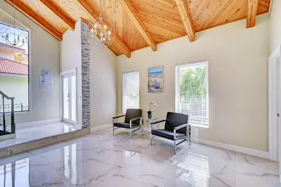 a living room with two chairs and a table at Luxury 5BR & 3BA Villa Walk to Hollywood Beach in Hollywood