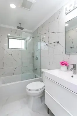 a white bathroom with a toilet and a tub and a sink at Fabulous 5BR & 3BA Villa near Hollywood Beach in Hollywood