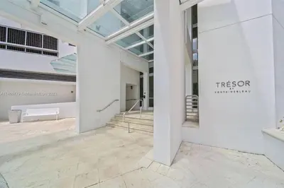an empty gallery with a sign on the wall of a building at Fontainebleau Miami Beach Junior Suite in Miami Beach