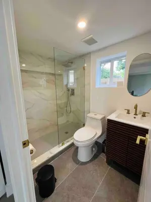 a bathroom with a shower and a toilet and a sink at La Casita in Miami
