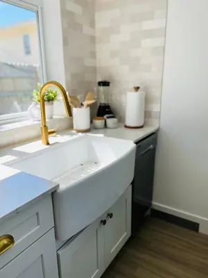 a white kitchen with a sink and a window at La Casita in Miami