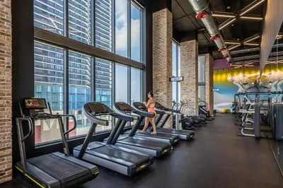 a woman running on treadmills in a gym at Sublime property in the heart of downtown Miami in Miami