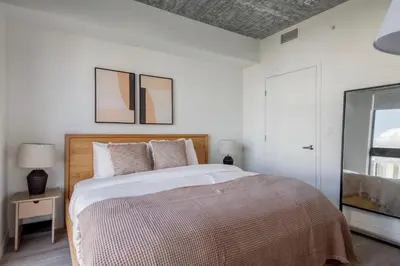 a white bedroom with a large bed and a window at Blueground Wynwood pool gym nr Design Dist MIA-99 in Miami