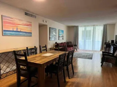 a living room with a wooden table and chairs at Lovely 2 bedroom with side ocean view in Hollywood