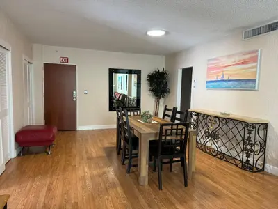 a dining room with a table and chairs at Lovely 2 bedroom with side ocean view in Hollywood