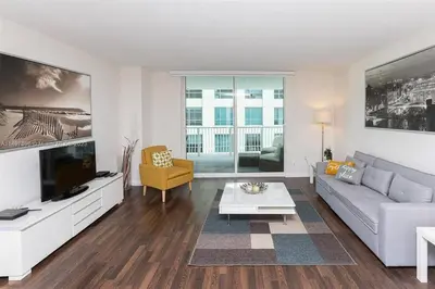 a living room with a couch and a tv at Entire Condo in Brickell steps from Brickell City Centre in Miami